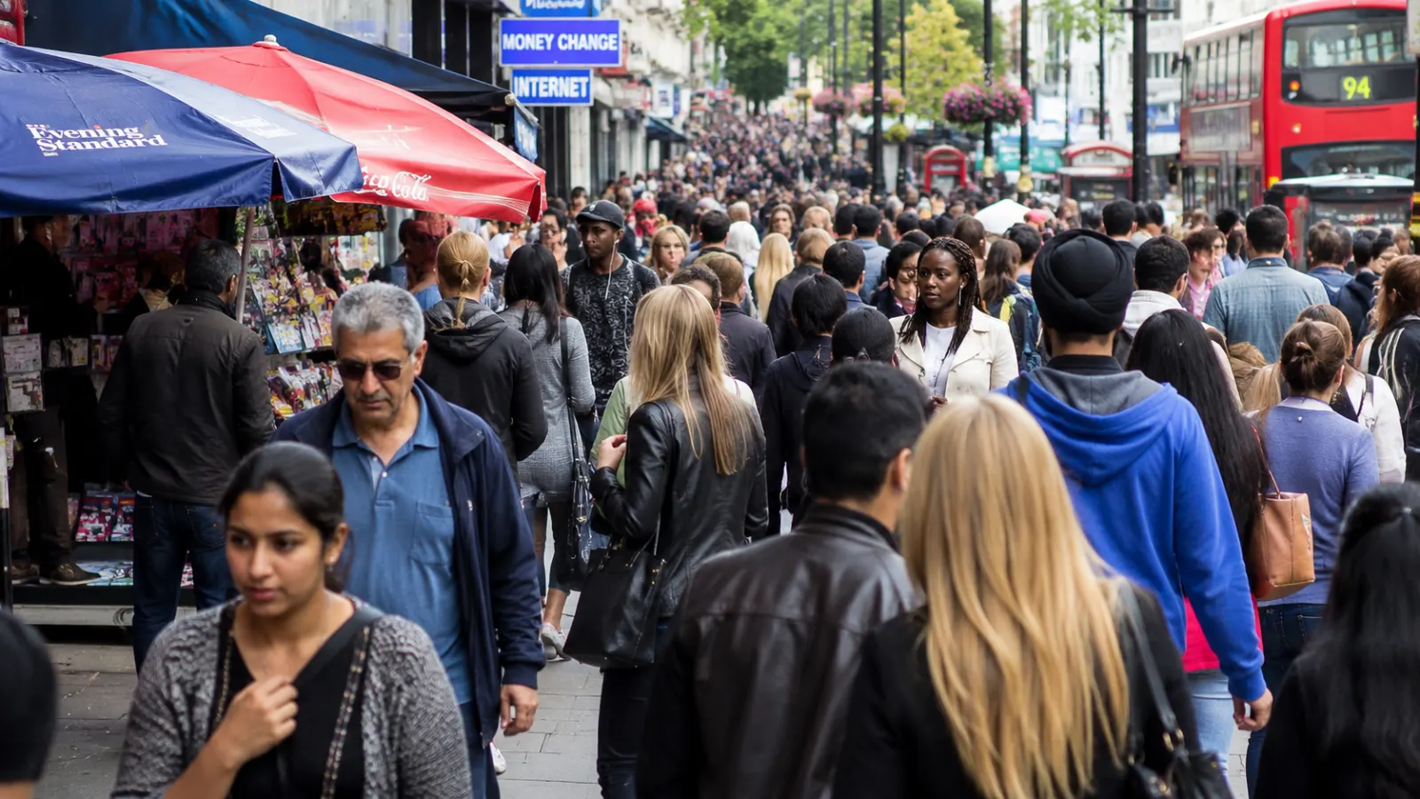 Residents from different backgrounds sharing a busy urban neighbourhood shaped by migration.