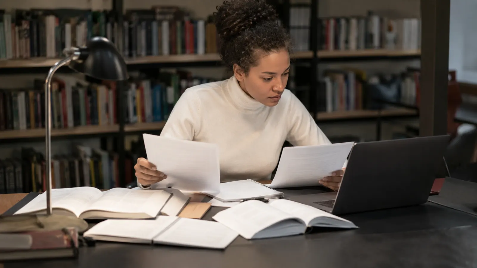 Researcher checking an unfamiliar source against original evidence and independent coverage